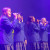 Four vocalists performing on stage under lights at Concordia in Concert 2022