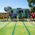 The 2021 House Captains from all four Houses line up on the running track, holding House flags, at our ELC and Primary School Sports Day