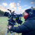 Old Concordian and cinematographer Maxx Corkindale operating an Arri camera system in an open field on a professional shoot