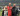 Dakota in a red soccer uniform with his mum standing on his left and his dad on the right