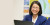 An international student smiles at the camera