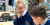 A Primary School student looking through a magnifying glass and smiling