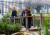 Three ELC children playing together on a bridge in the ELC garden at St John's Campus