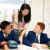 Two students receiving assistance from their Chinese language teacher