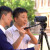 Two students operating a video camera in the Quad during a Media lesson