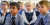 Two boys sit in the foreground listening to the teacher with other students sitting behind