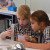 Two Year 3 students measuring water in a science lab