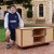 A Year 12 student rests his hand on top of his completed Design, Technology and Engineering project - a timber entertainment unit
