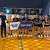 Concordia's Senior A IGSSA Volleyball team and their coach wearing their championship medals while holding an IGSSA Champions banner and a wooden shield