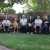 Visiting poet and author Steven Herrick sitting with a group of students, each holding one of his books, in the garden outside the Chapel