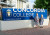 Two ELC and Primary School students standing alongside a Concordia College sign on day one of Term 1, 2022