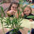 Two ELC students looking at a caterpillar on a plant