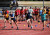 Four students running in a race at Sports Day