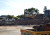 A machine sits atop a pile of rubble at the building site for the new Gymnasium