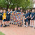A group of students standing with Karina Penhall and helping to hold the large-scale artwork she completed while at Concordia as Artist-in-Residence