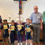 Four children holding their Storybook Bibles, which were given to them by members of St Peters Lutheran Church, three of whom are pictured with the children