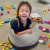 An ELC child sitting in a basket surrounded by colourful toys