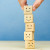 Advertisement for 2023 Wellbeing Barometer Special Report from SchoolTV shows fingers stacking blocks with faces signifying different emotions