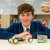 A student with the radio controlled car he worked on and exhibited at the Capabilities in Action (MYP) exhibition