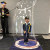 A student smiles while inside a bubble that extends from the floor to the space above his head, during an incursion with The Scientific Bubble Show