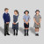 Four students standing while wearing Concordia College uniform - two in winter uniform and two in summer uniform